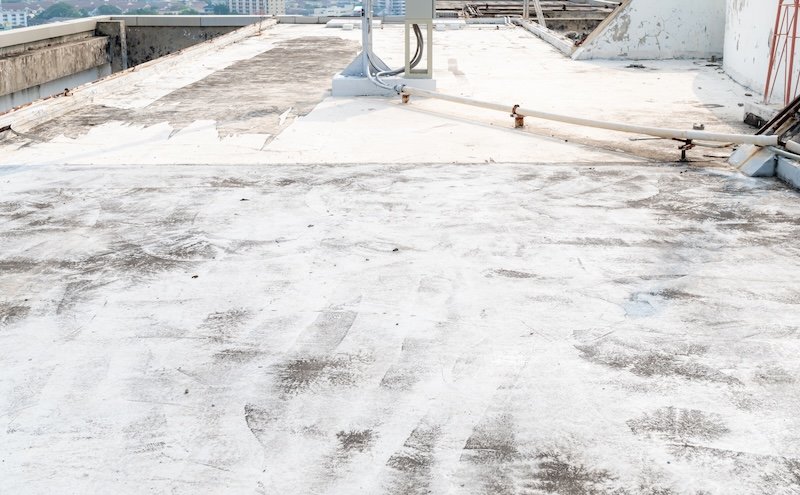 Deck slab made of concrete cracks of small formed a long line due to the change of the temperature outside. The background color of the roof deck has peeled off. Because of the deterioration of color.