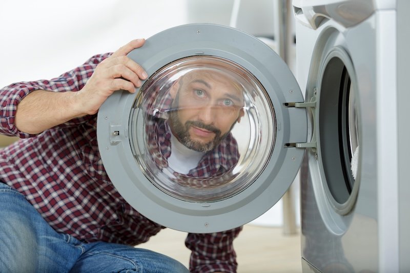 a plumber hidding washing machine