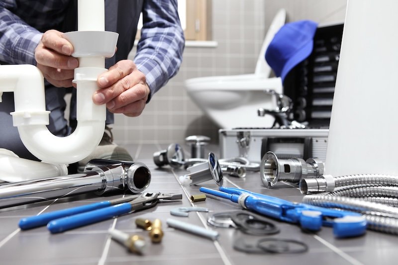 plumber at work in a bathroom, plumbing repair service, assemble and install concept plumbing maintenance