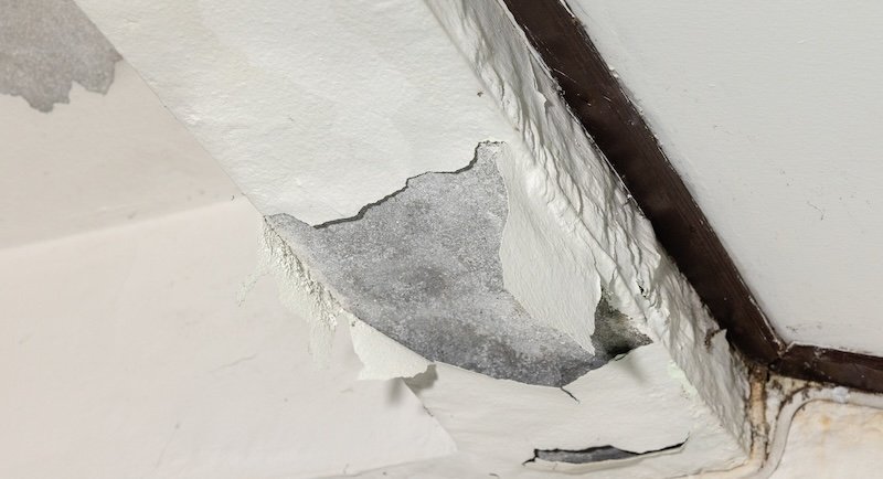 Water leaking from concrete slab porch into room below.