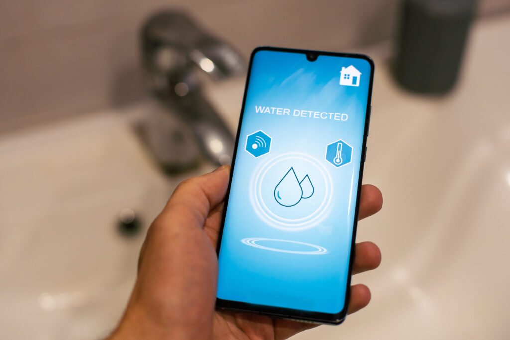 Smart Home: Man Controlling Heating Using App. High quality photo hidden leaks