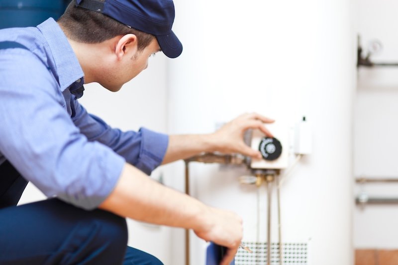plumber fixes temperature on water heater